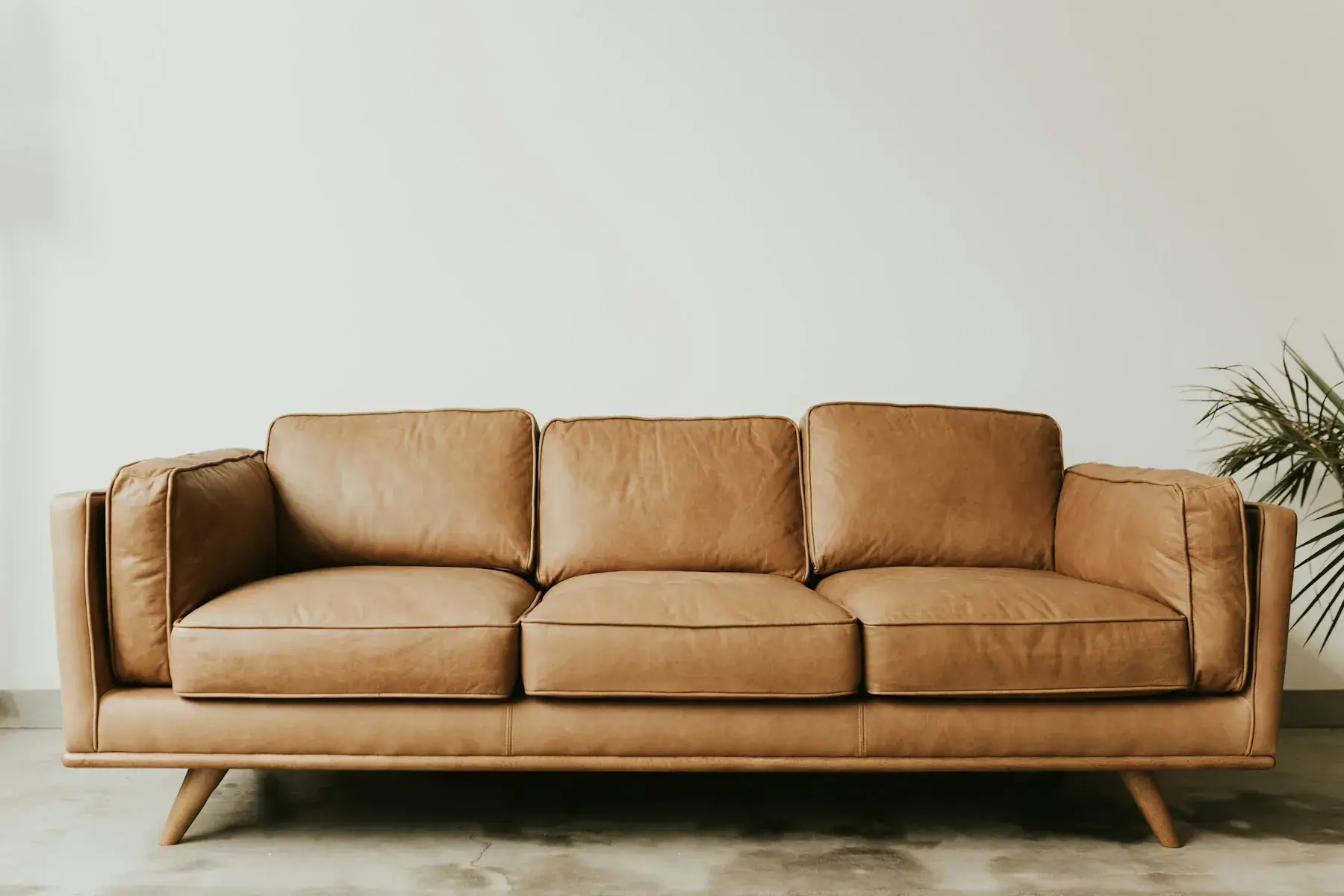 Tan three-seater sofa