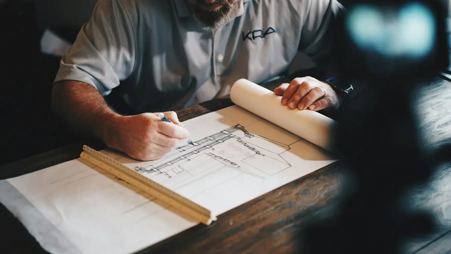 Designer sketching furniture plans at a desk