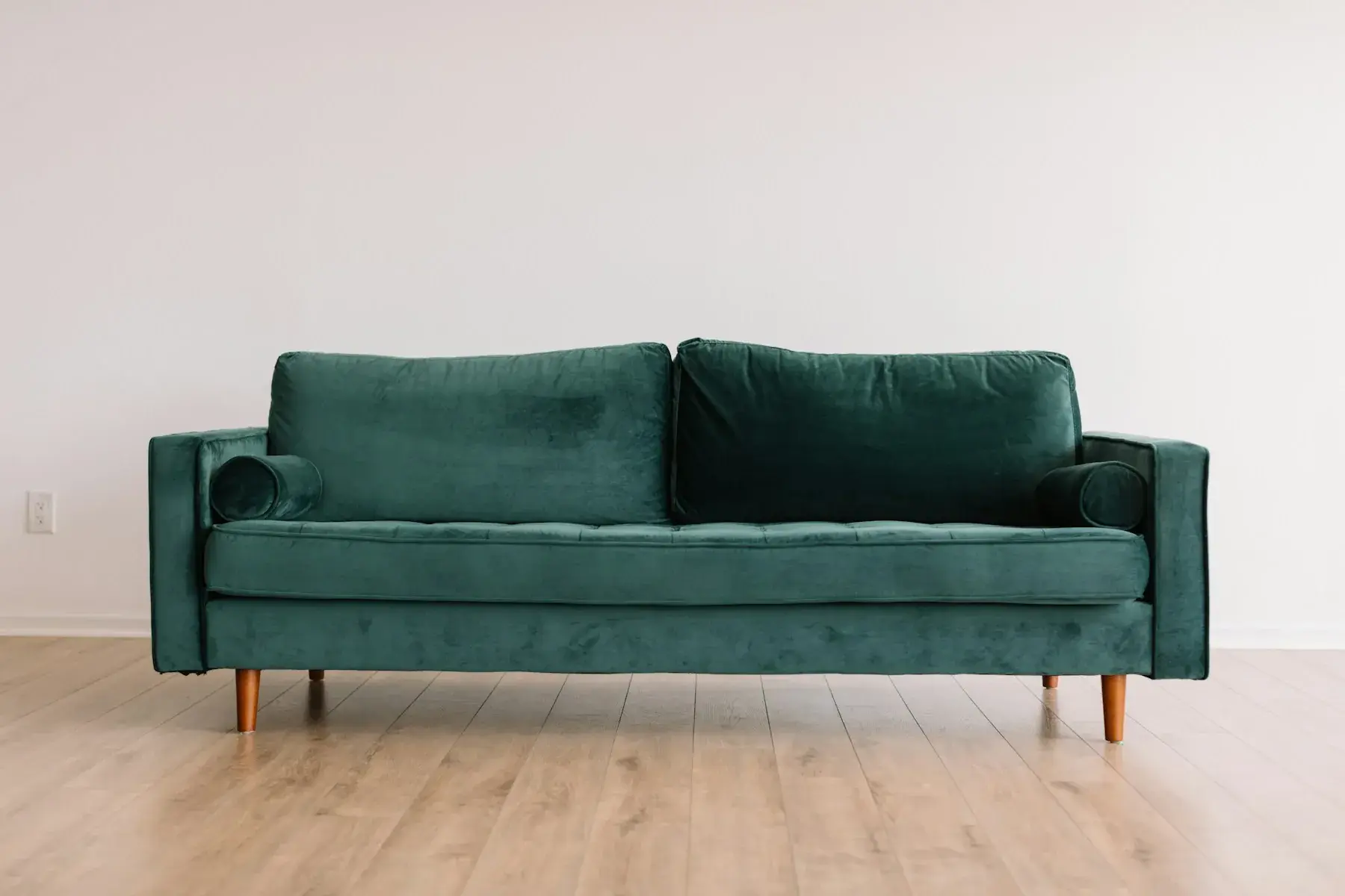 Green velvet three-seater sofa